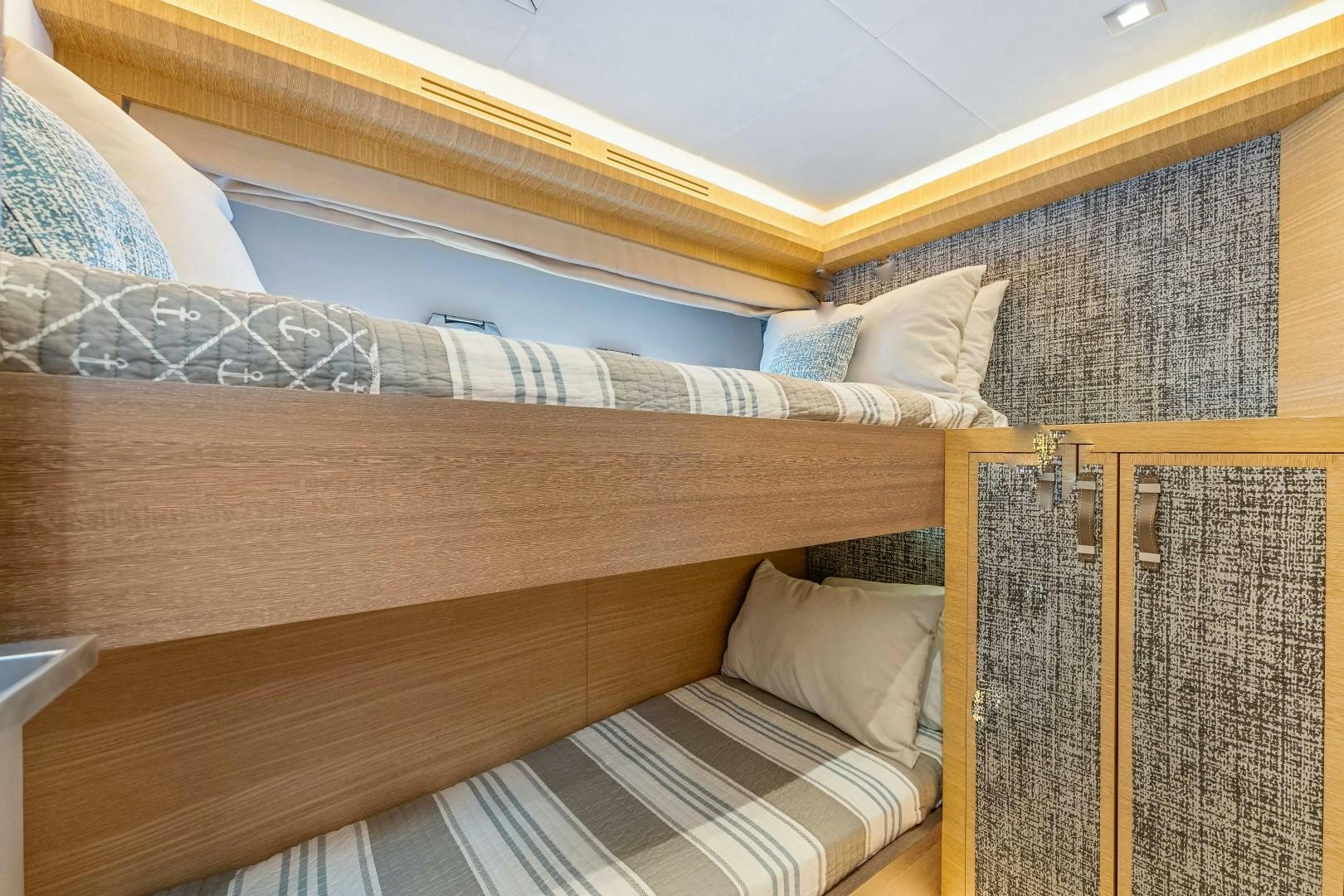 a bed with a wooden frame aboard MONTE CARLO Yacht for Sale