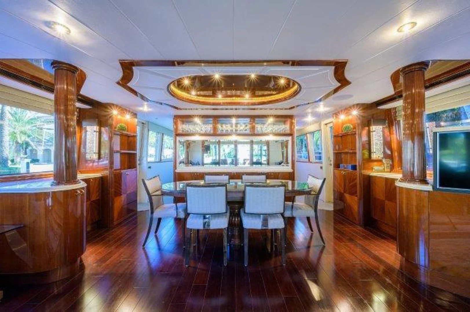 a room with tables and chairs aboard TRYST Yacht for Sale