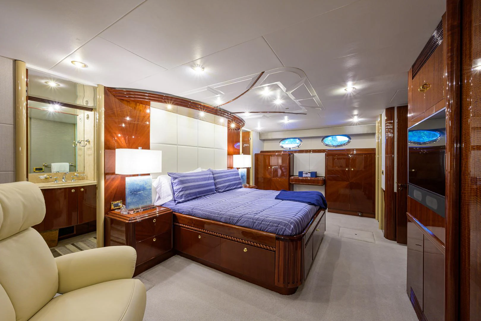 a bedroom with a bed and a desk aboard TRYST Yacht for Sale