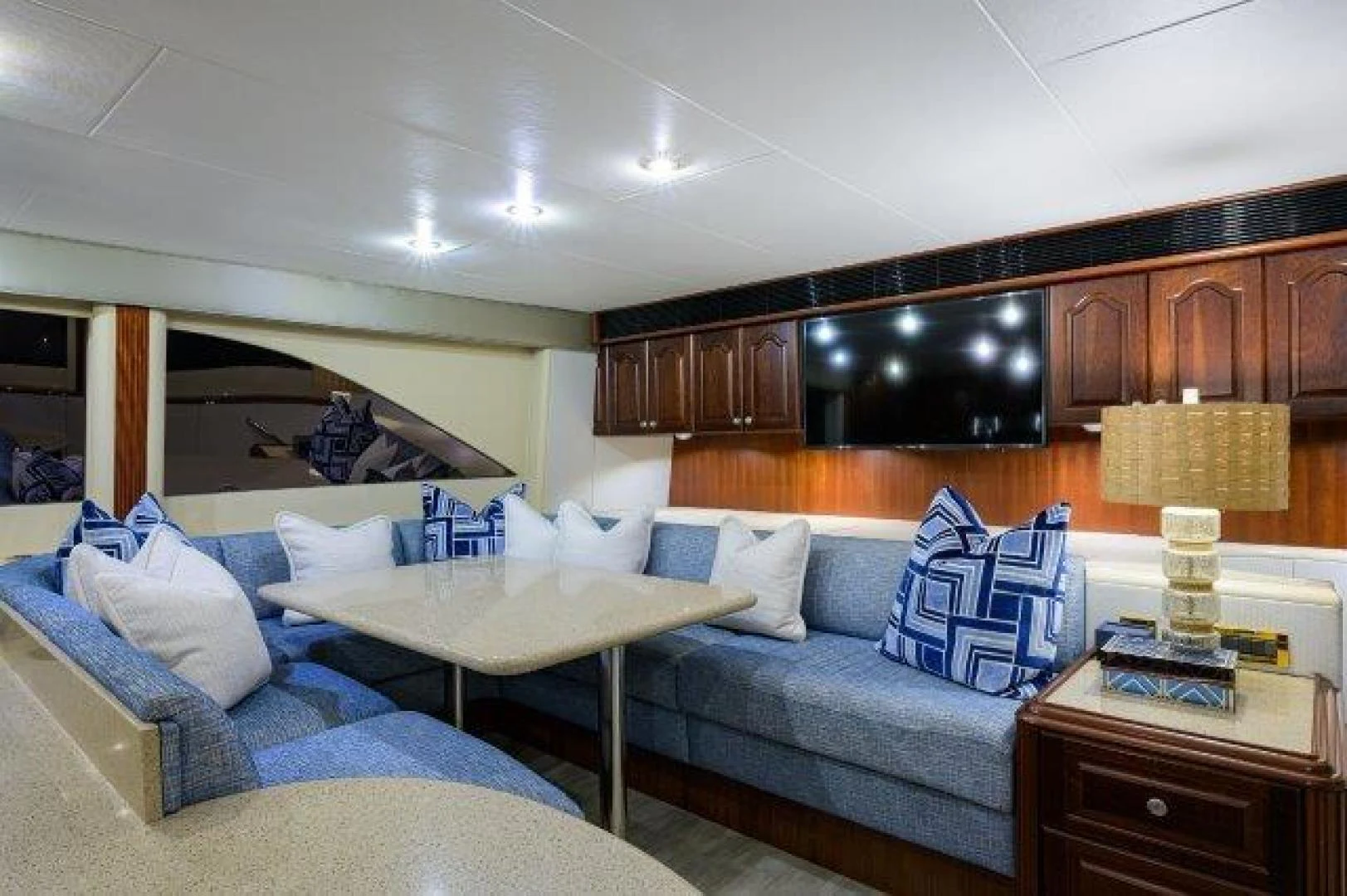 a living room with a couch and a television aboard TRYST Yacht for Sale