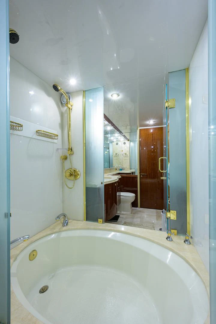 a bathroom with a bathtub and toilet aboard TRYST Yacht for Sale