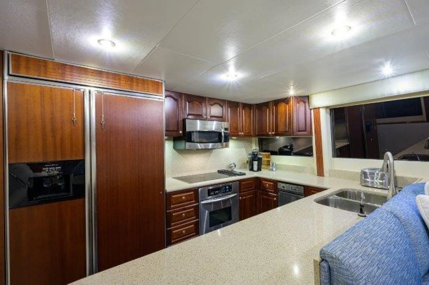 a kitchen with wooden cabinets aboard TRYST Yacht for Sale
