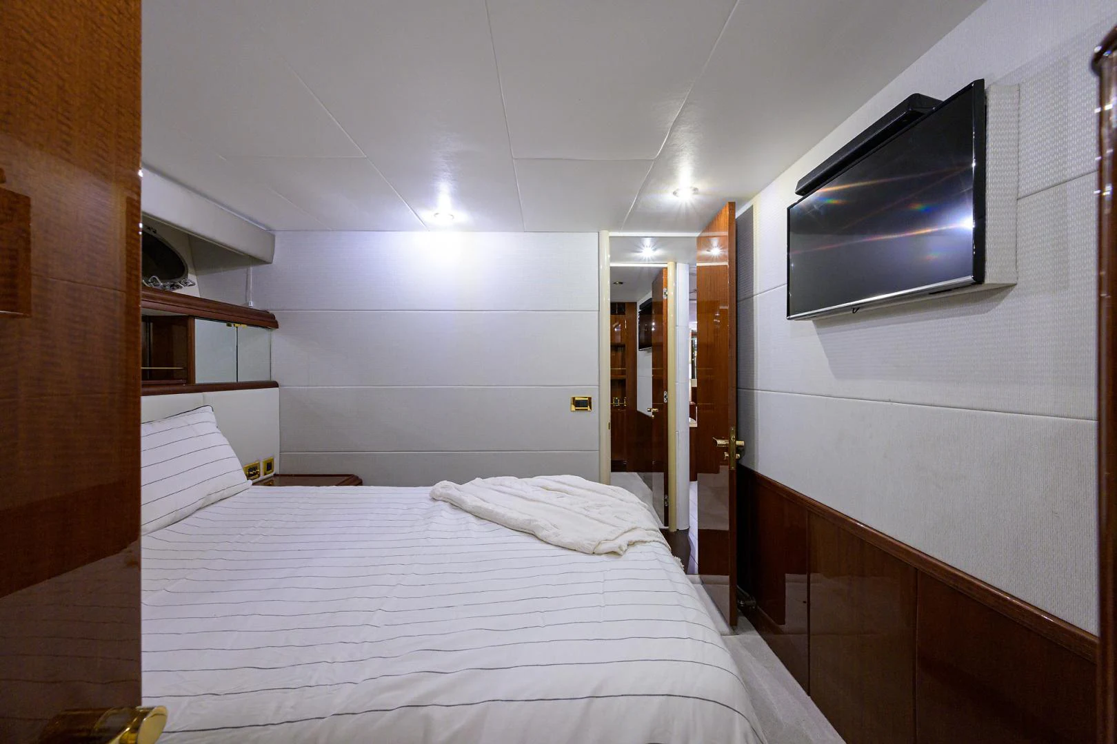 a bedroom with a bed and tv aboard TRYST Yacht for Sale