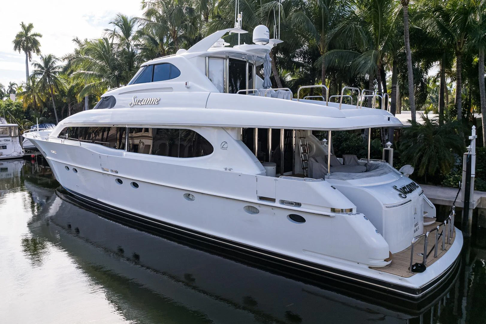a white boat in a tropical setting aboard TRYST Yacht for Sale
