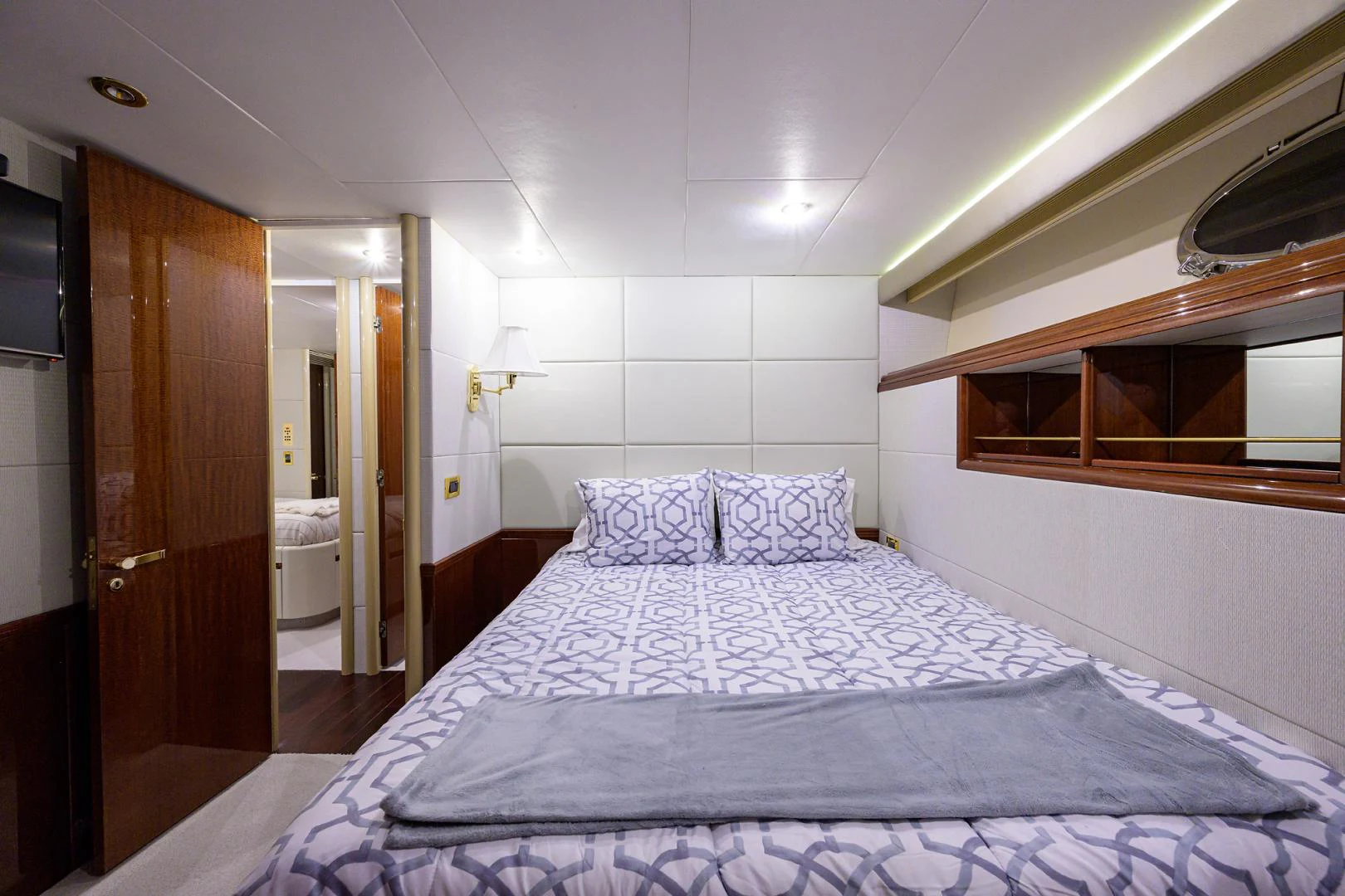 a bedroom with a bed and a mirror aboard TRYST Yacht for Sale