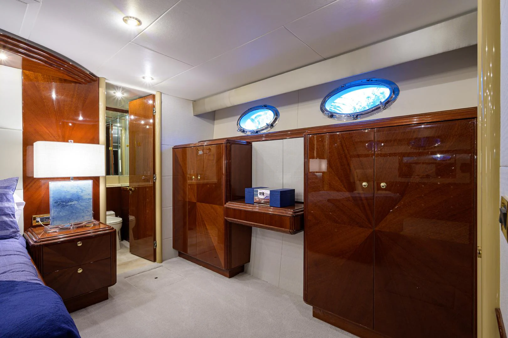 a room with a large mirror and a desk with a blue light aboard TRYST Yacht for Sale