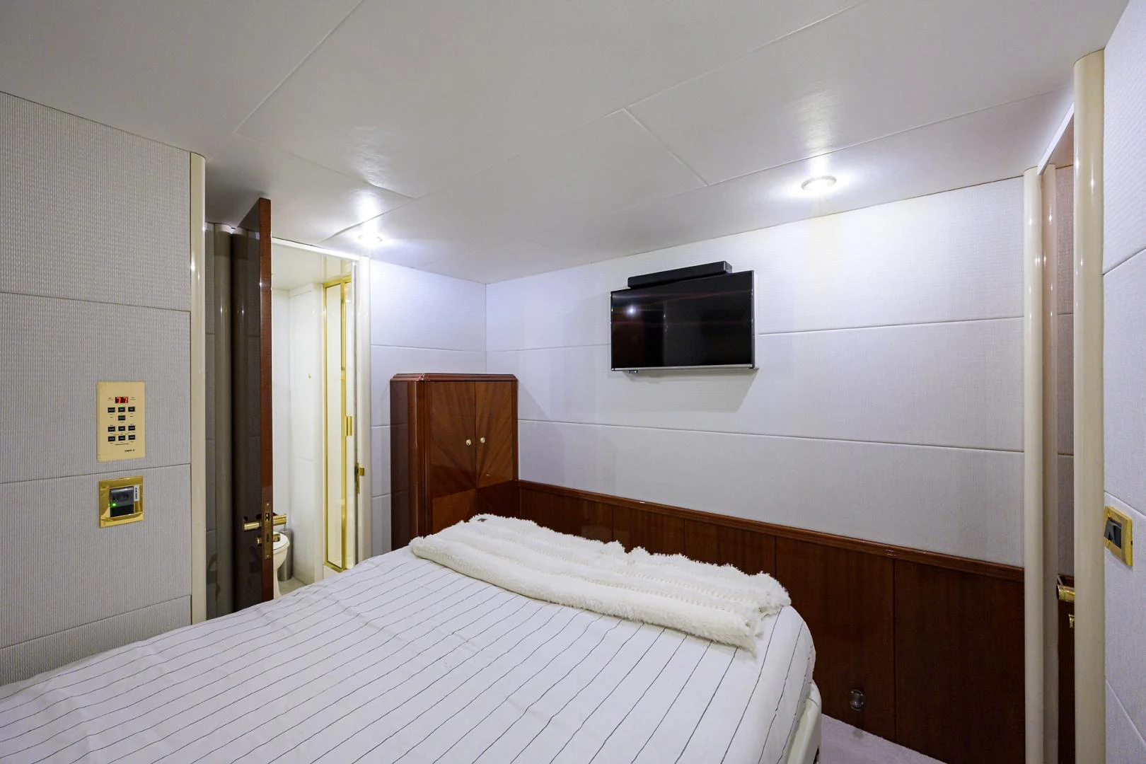a hotel room with a television on the wall aboard TRYST Yacht for Sale