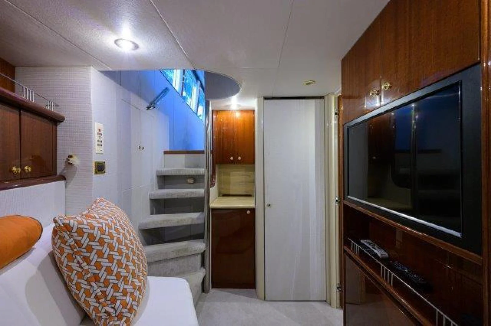 a room with a bed and a chair aboard TRYST Yacht for Sale
