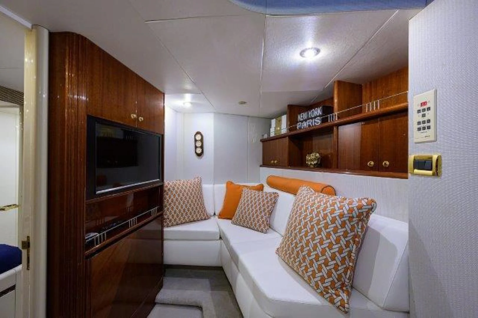 a room with a couch and a television aboard TRYST Yacht for Sale