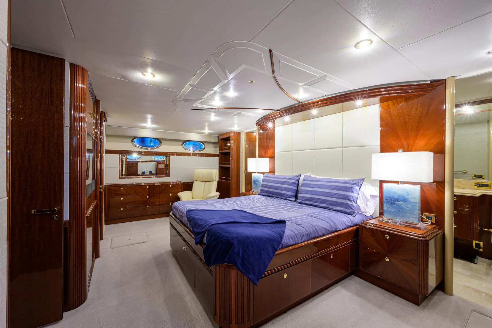 a room with a bed and a desk aboard TRYST Yacht for Sale
