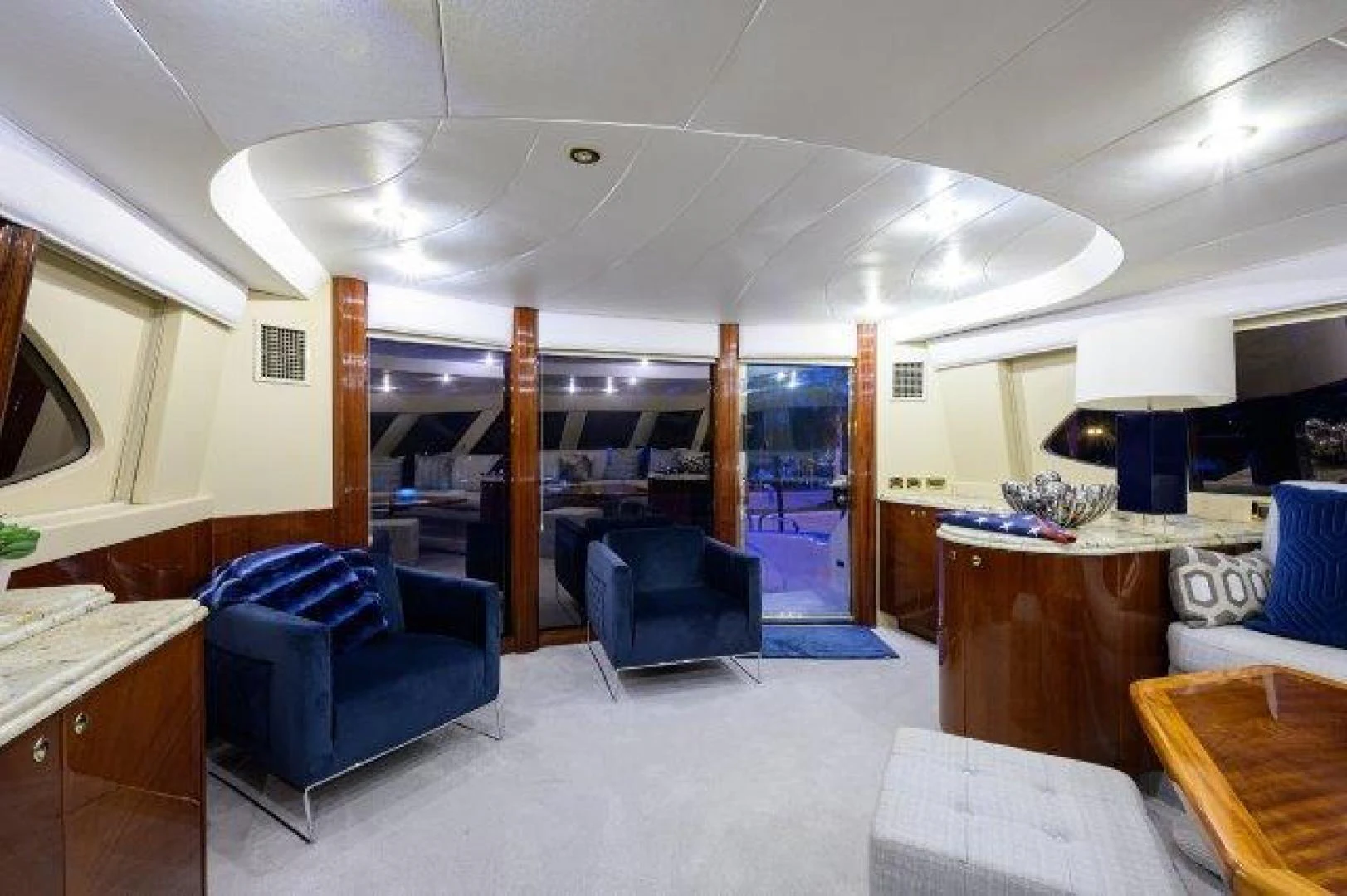 a room with a table chairs and a large window aboard TRYST Yacht for Sale