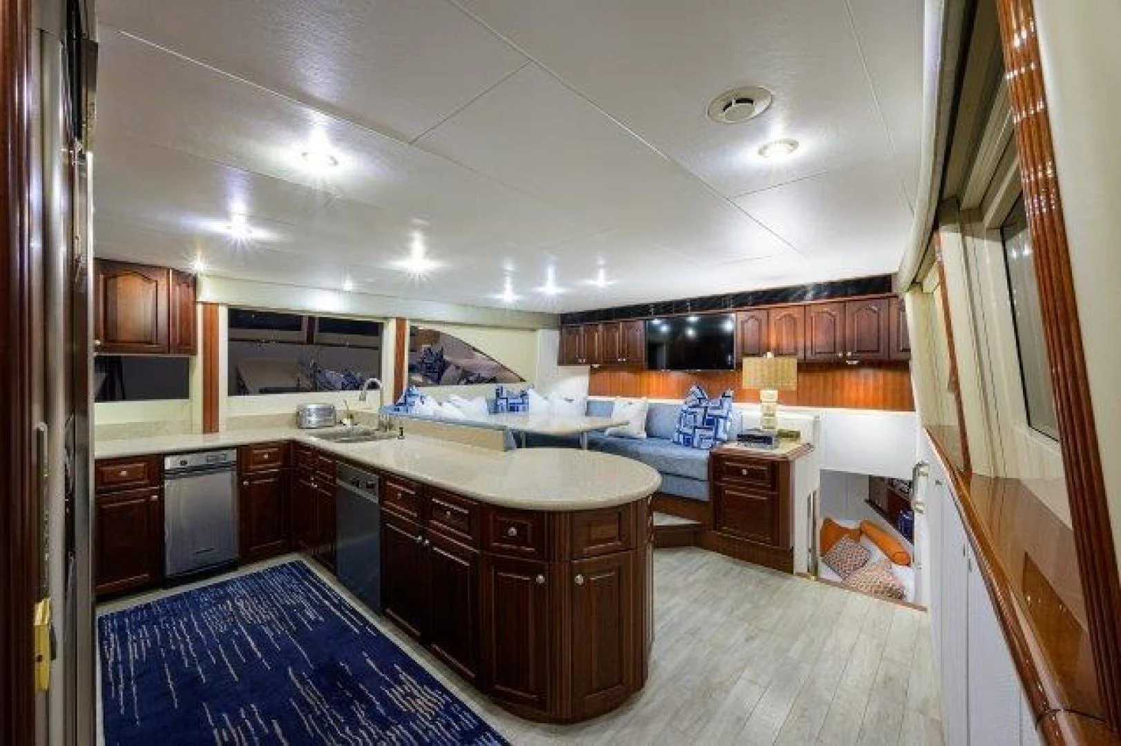 a large kitchen with wooden cabinets aboard TRYST Yacht for Sale
