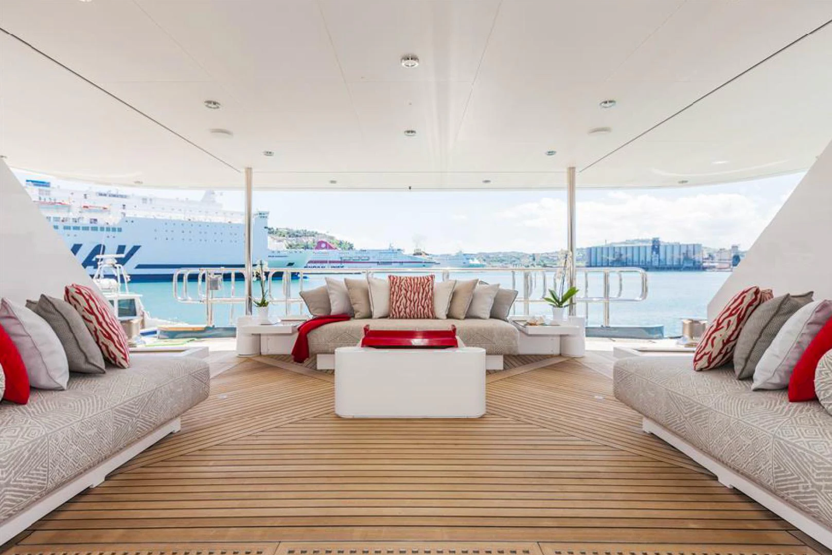 a room with a couch and a table and a view of the water aboard AMORE MIO 2 Yacht for Sale