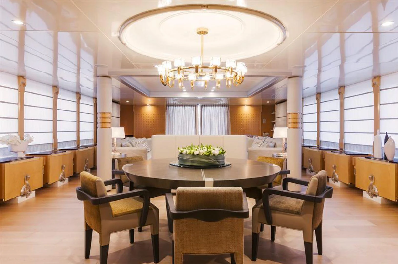 a room with a table chairs and a chandelier aboard AMORE MIO 2 Yacht for Sale