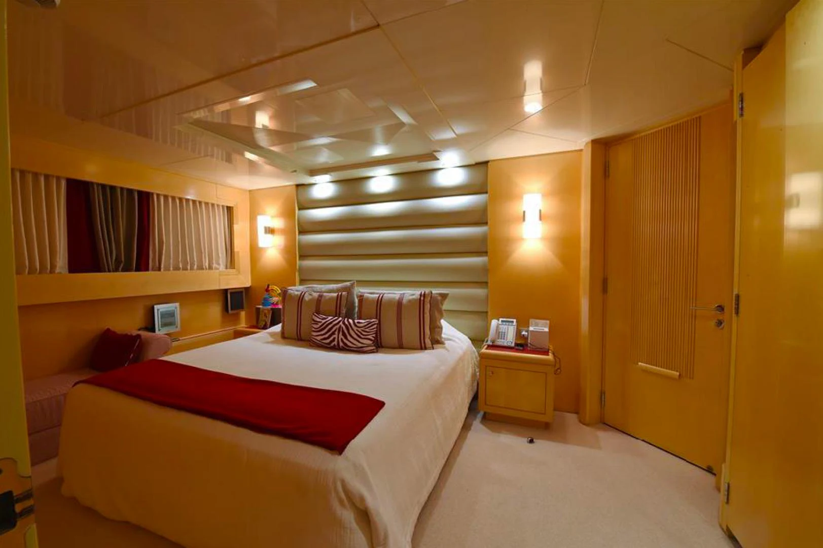 a bedroom with a bed and a bookcase aboard AMORE MIO 2 Yacht for Sale