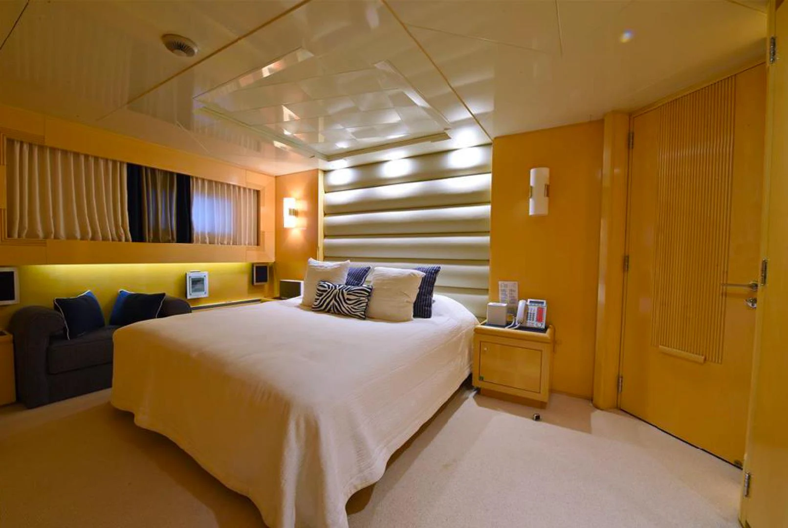 a room with a bed and a couch aboard AMORE MIO 2 Yacht for Sale