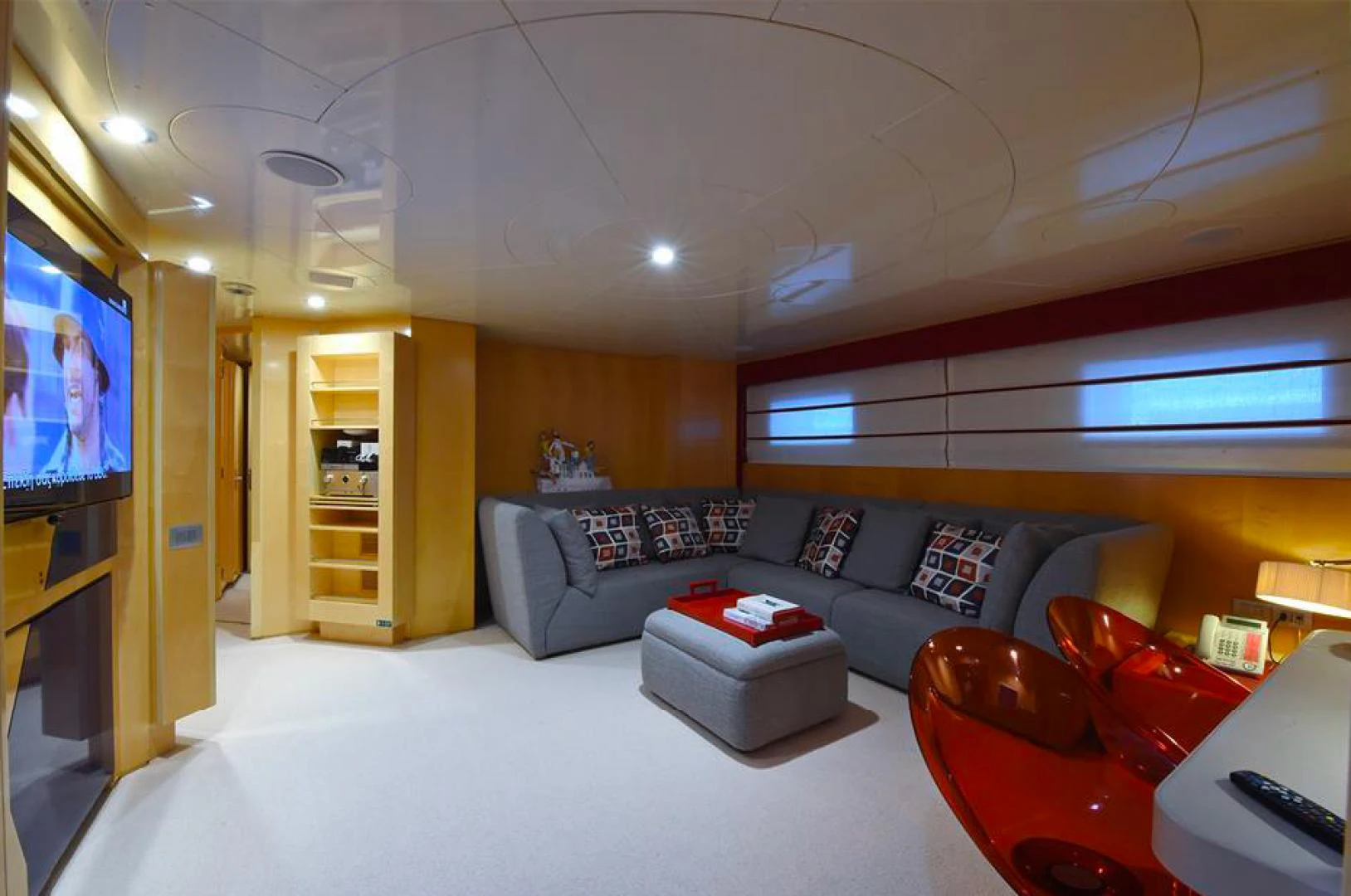 a living room with a couch and a tv aboard AMORE MIO 2 Yacht for Sale