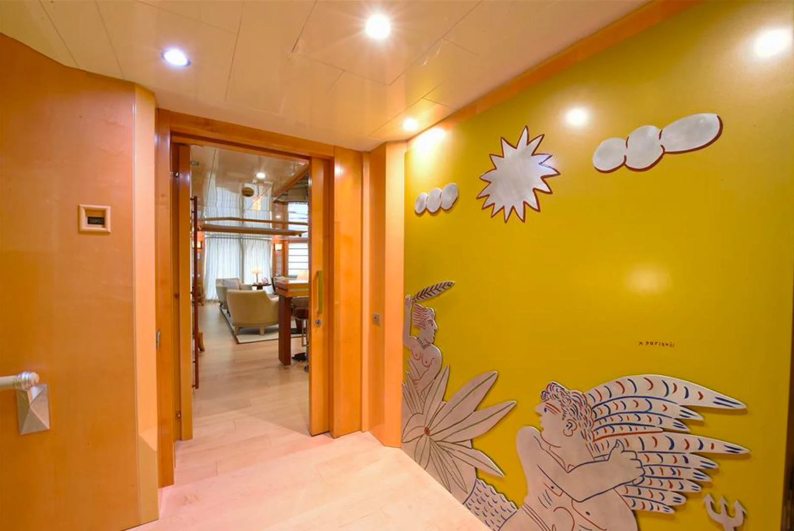 a room with a yellow wall and a painting on the wall aboard AMORE MIO 2 Yacht for Sale