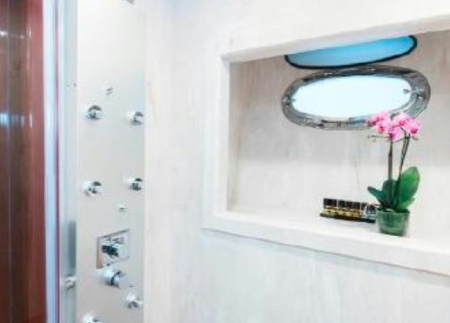 a mirror with a flower on the side aboard ALBATOR 2 Yacht for Sale