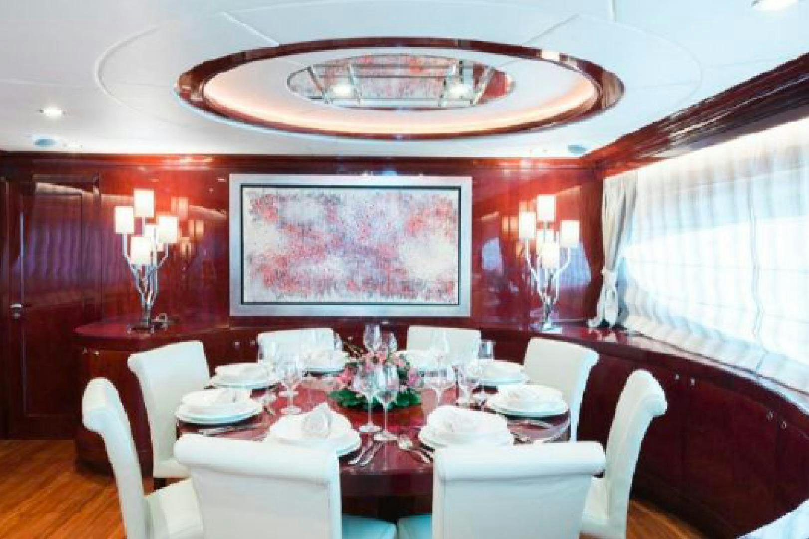 a dining room with a table set aboard ALBATOR 2 Yacht for Sale