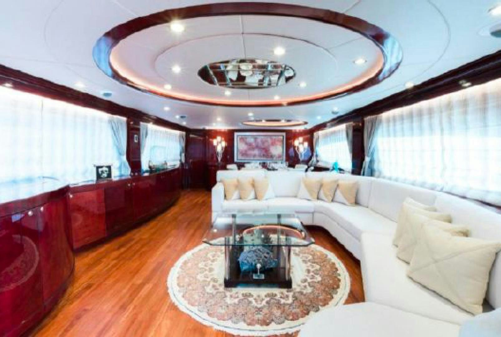 a living room with a large chandelier aboard ALBATOR 2 Yacht for Sale