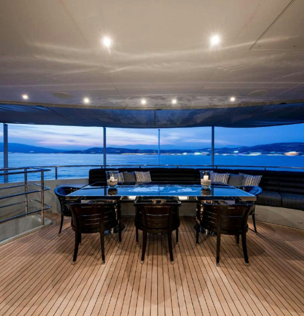 a table with chairs around it aboard BLISS Yacht for Charter