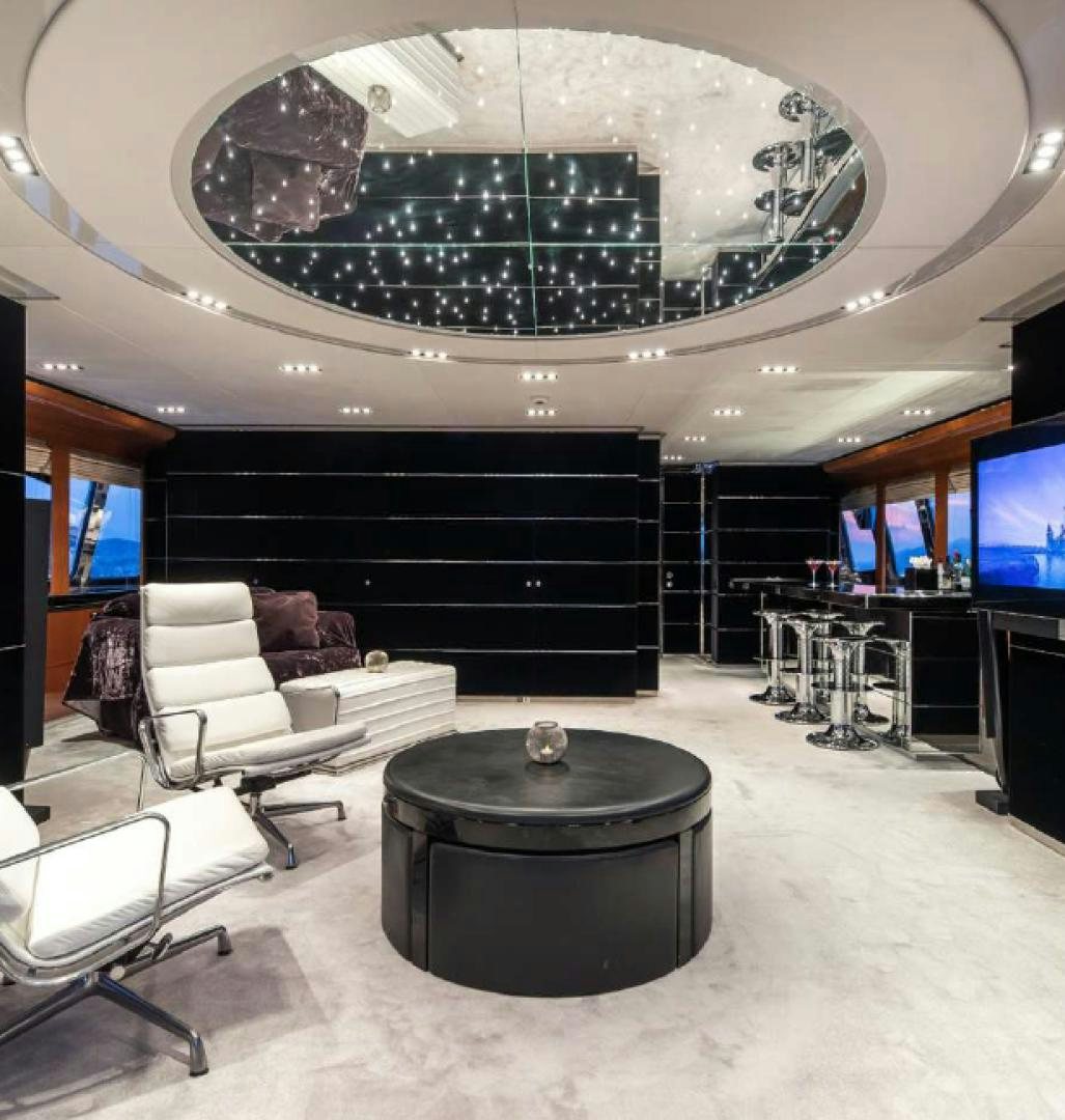 a room with a large chandelier aboard BLISS Yacht for Charter