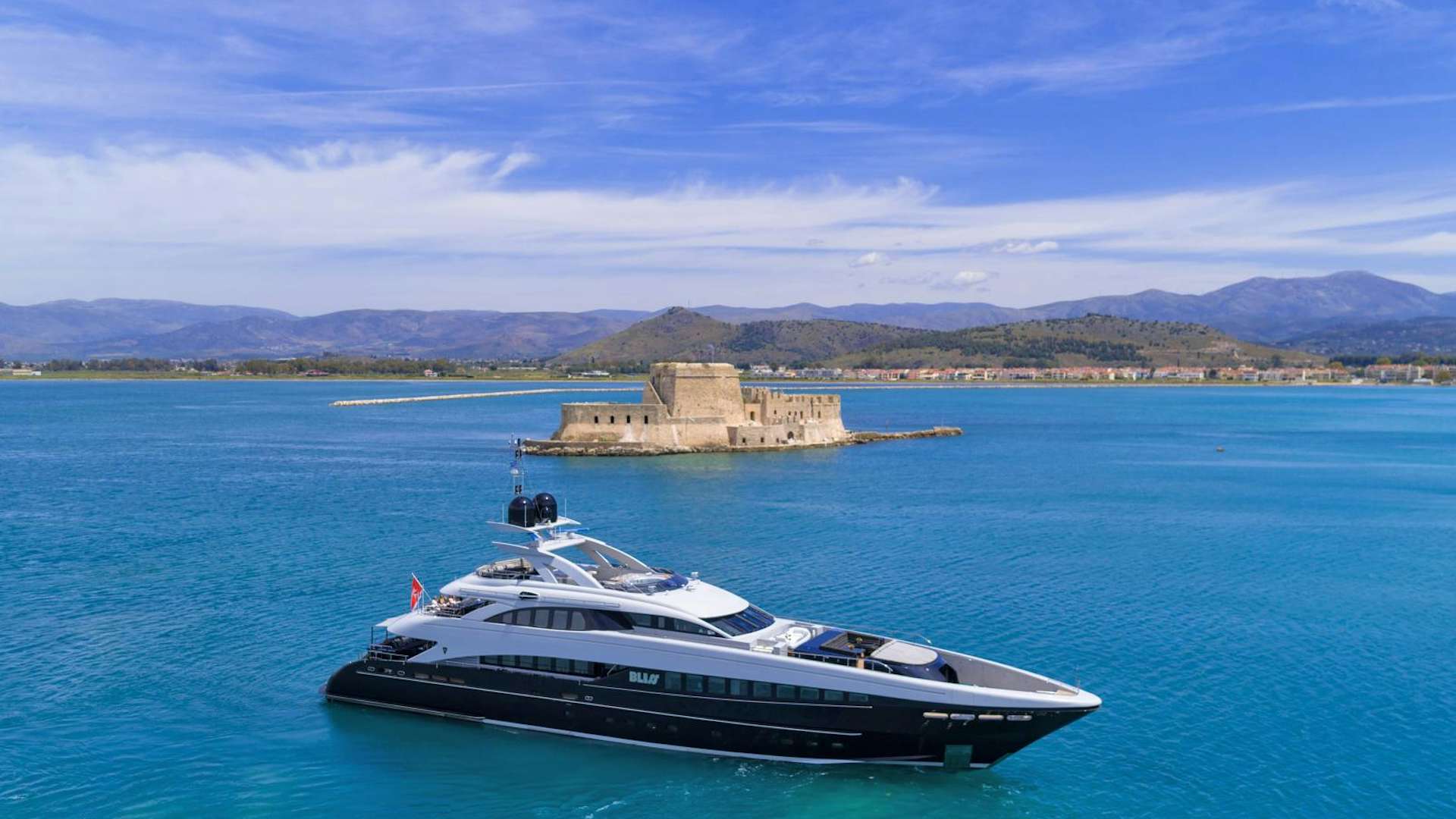a boat in the water with a small island in the background aboard BLISS Yacht for Sale