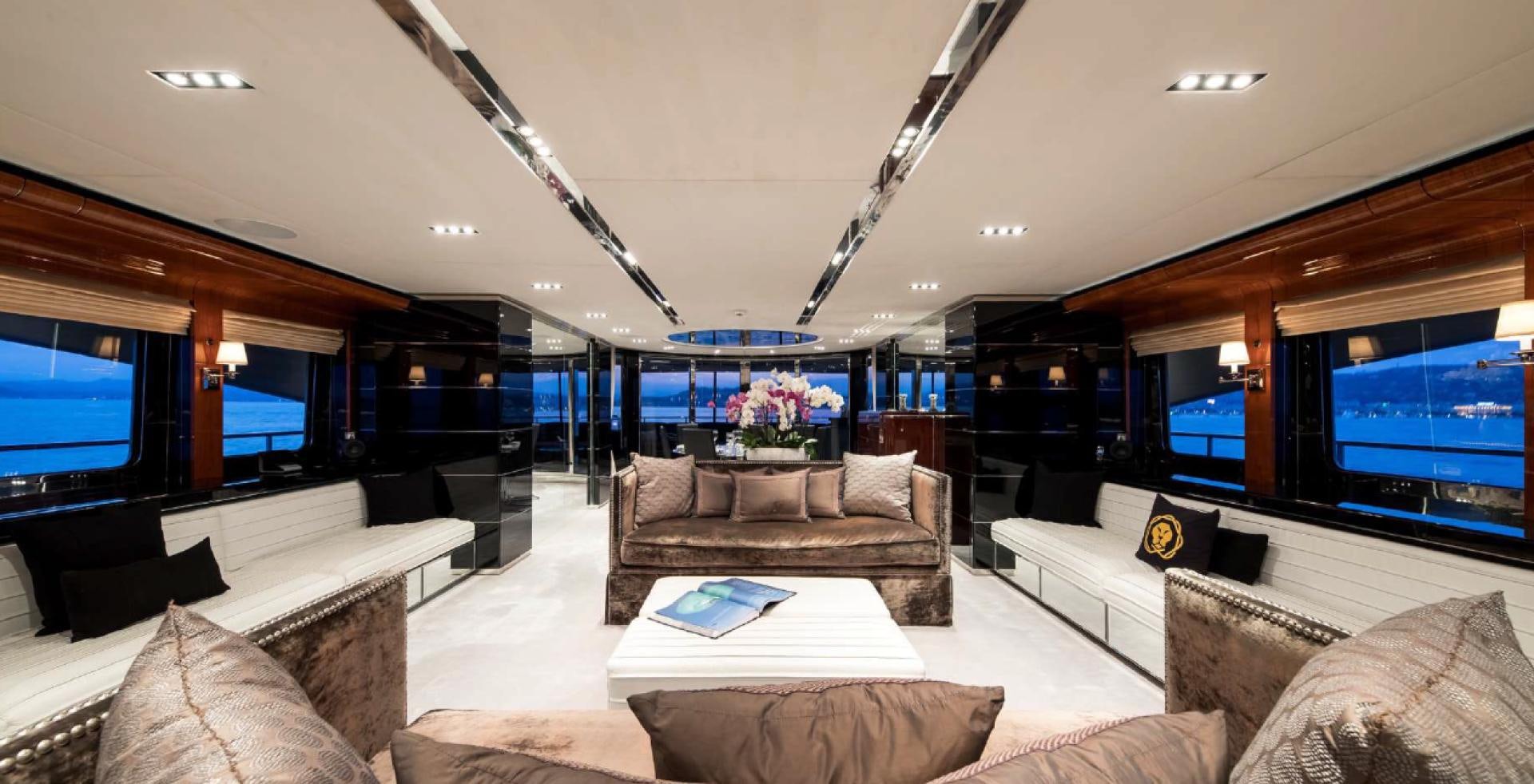 a living room with a large screen aboard BLISS Yacht for Charter