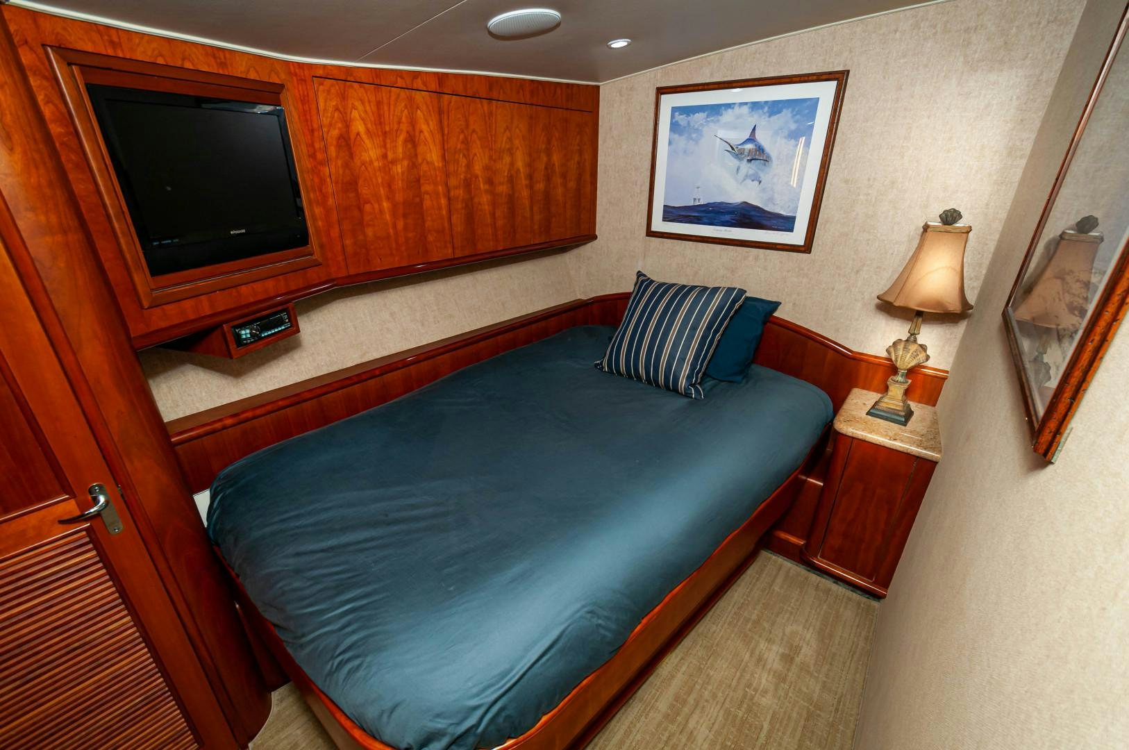 a bedroom with a bed and a television aboard BANK ON Yacht for Sale