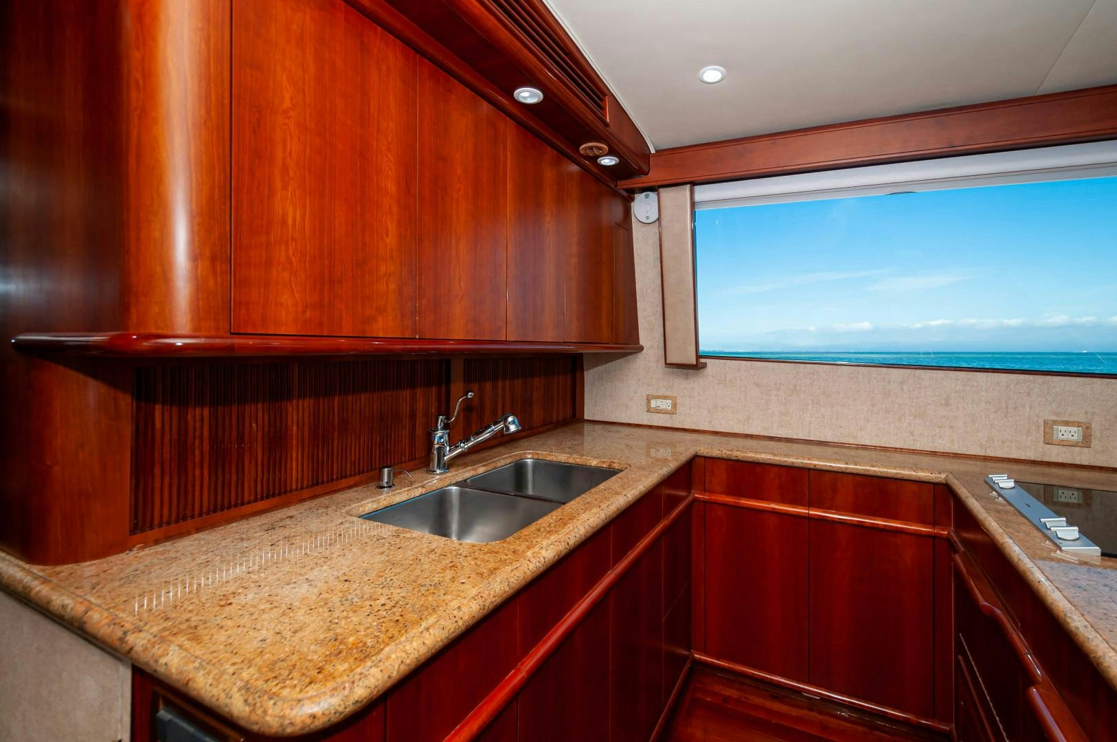 a kitchen with wooden cabinets aboard BANK ON Yacht for Sale