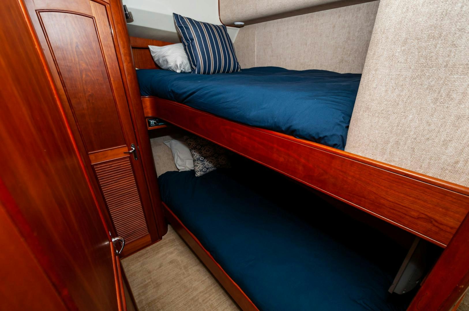 a bed with blue sheets aboard BANK ON Yacht for Sale