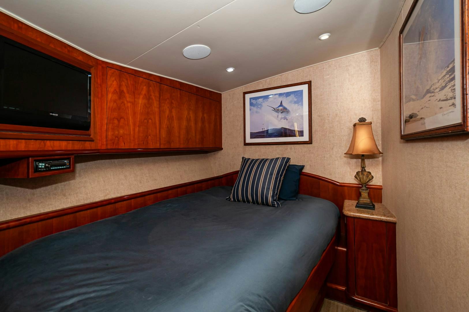 a bedroom with a bed and a television aboard BANK ON Yacht for Sale