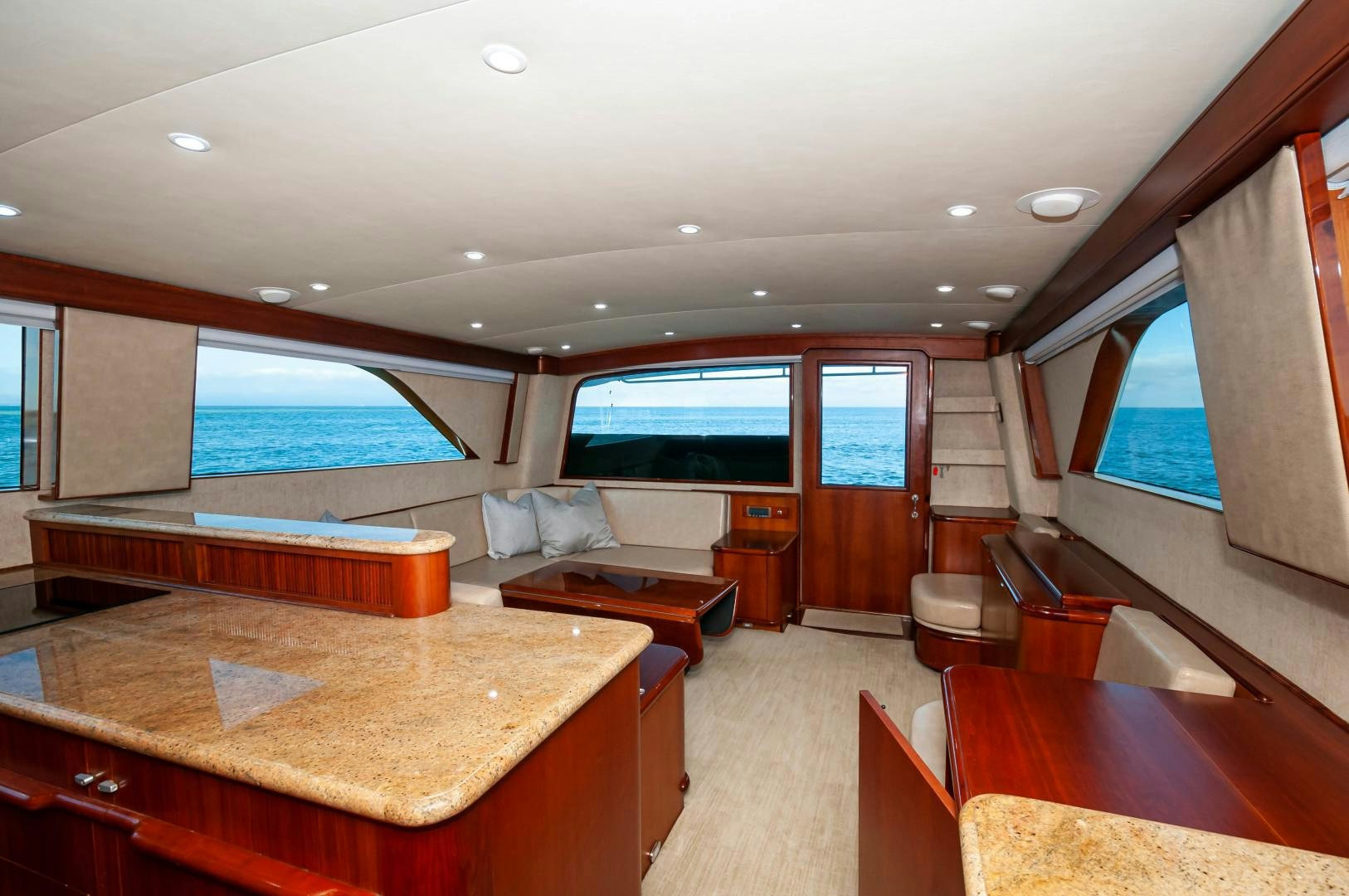 a room with a large window and a couch and a table aboard BANK ON Yacht for Sale