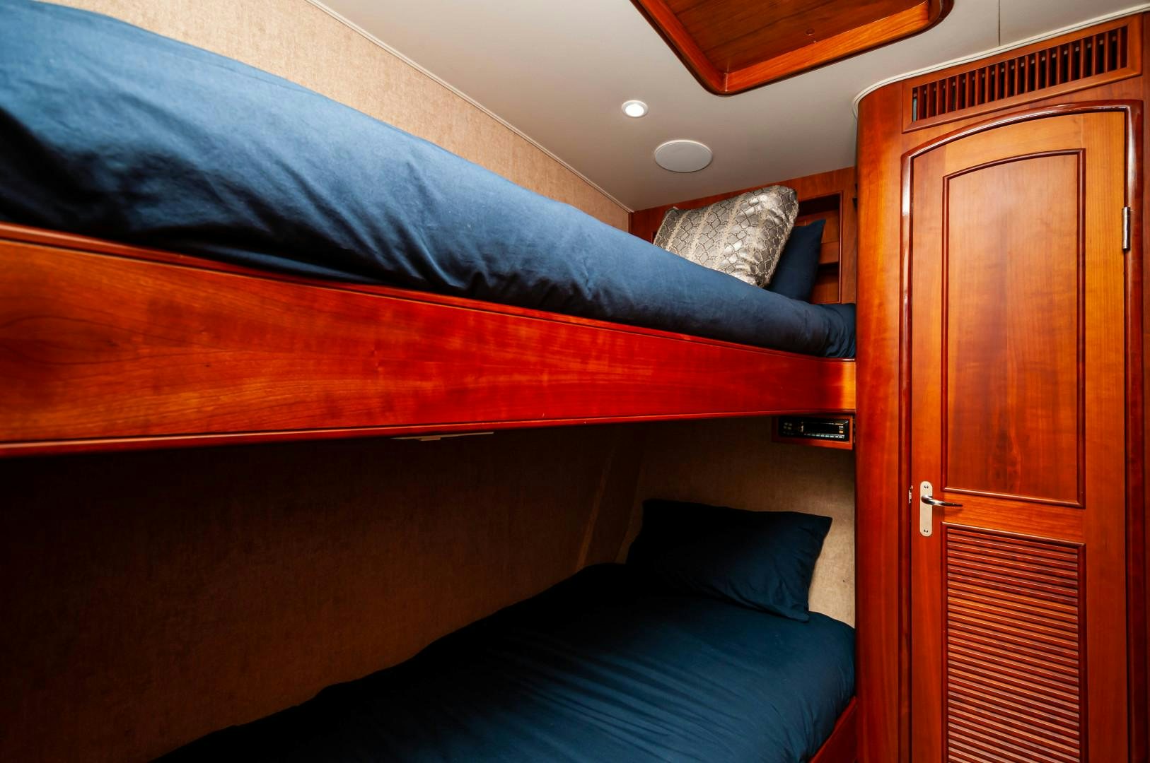 a bed with a blue comforter aboard BANK ON Yacht for Sale