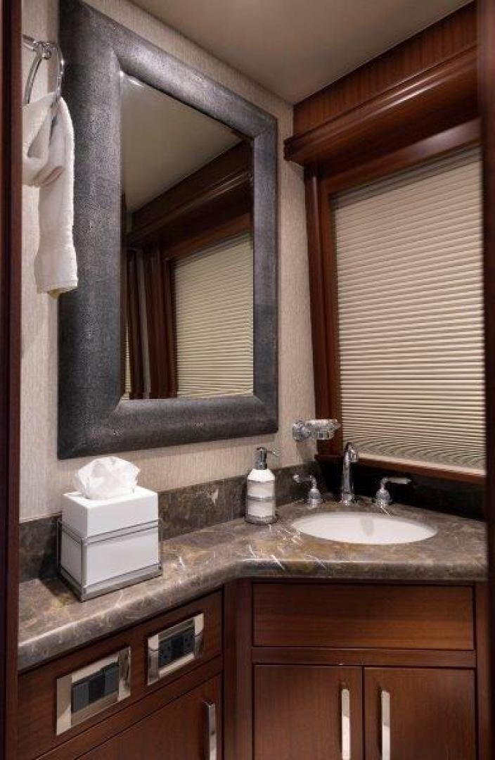 a bathroom with a mirror and a sink aboard CHERRY BOMB Yacht for Sale