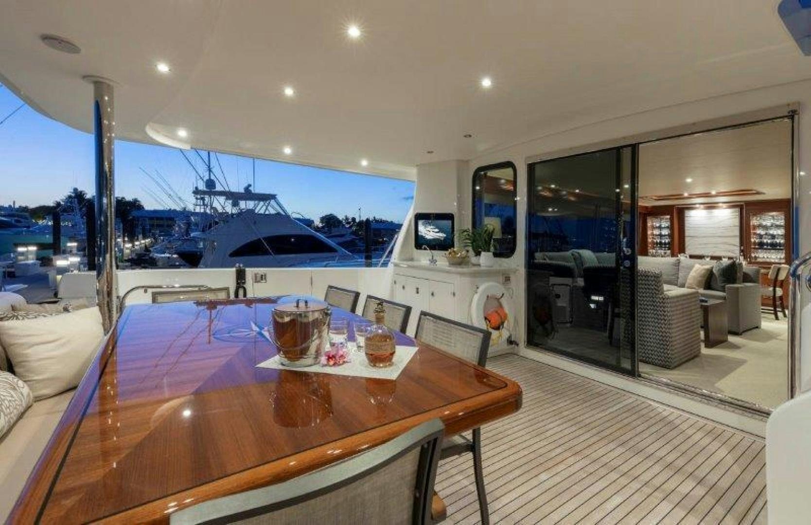 a large living room with a table and chairs aboard CHERRY BOMB Yacht for Sale