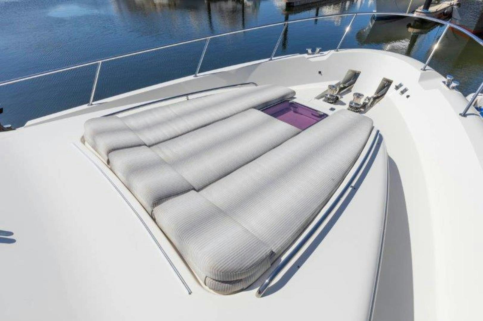 a white boat with a purple ribbon aboard CHERRY BOMB Yacht for Sale