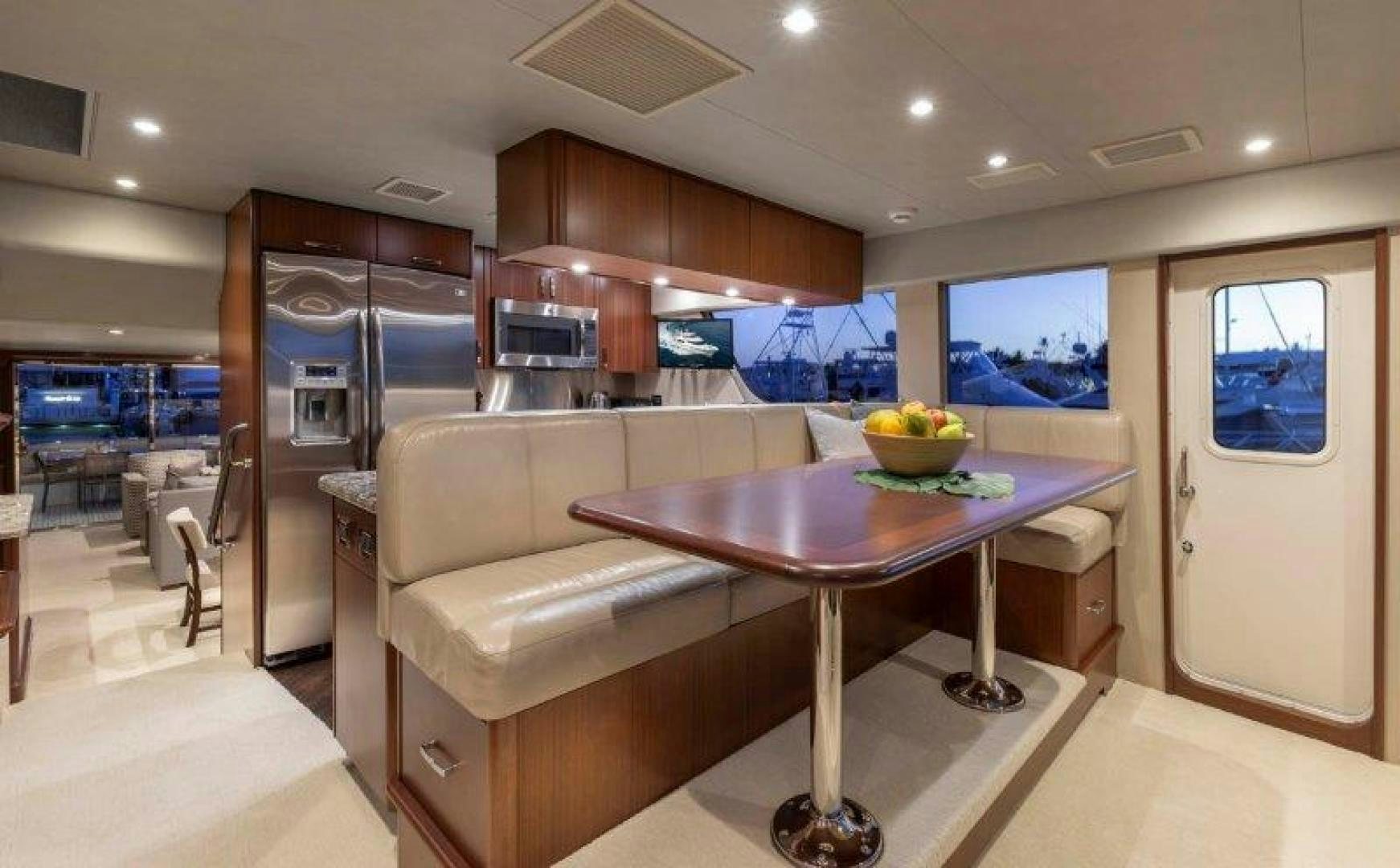 a kitchen with a table and couch aboard CHERRY BOMB Yacht for Sale