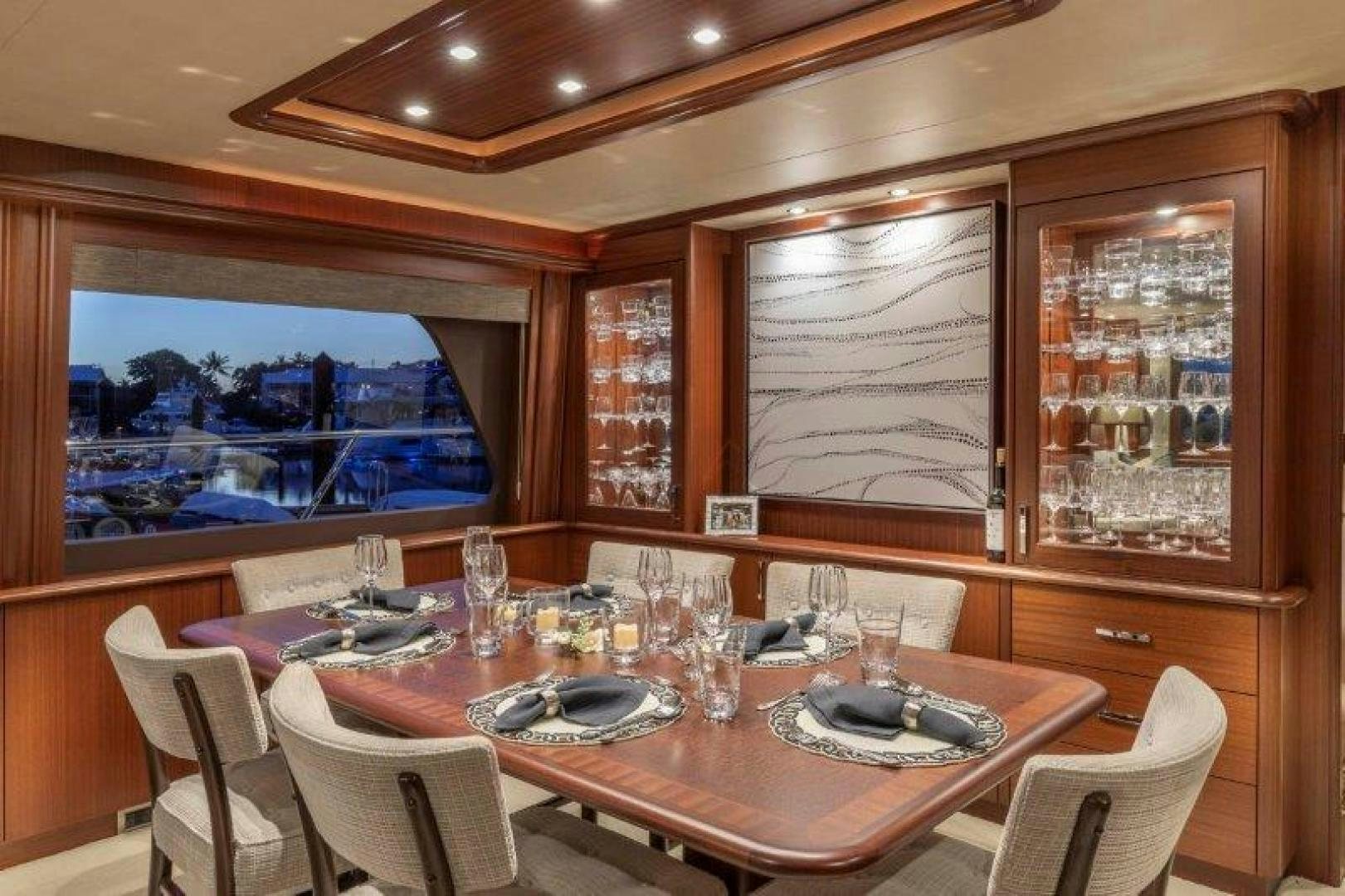 a dining room with a large window aboard CHERRY BOMB Yacht for Sale
