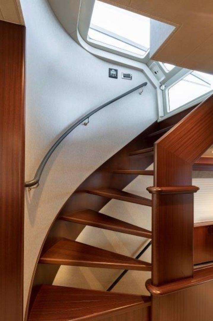 a wooden staircase with a light on the ceiling aboard CHERRY BOMB Yacht for Sale