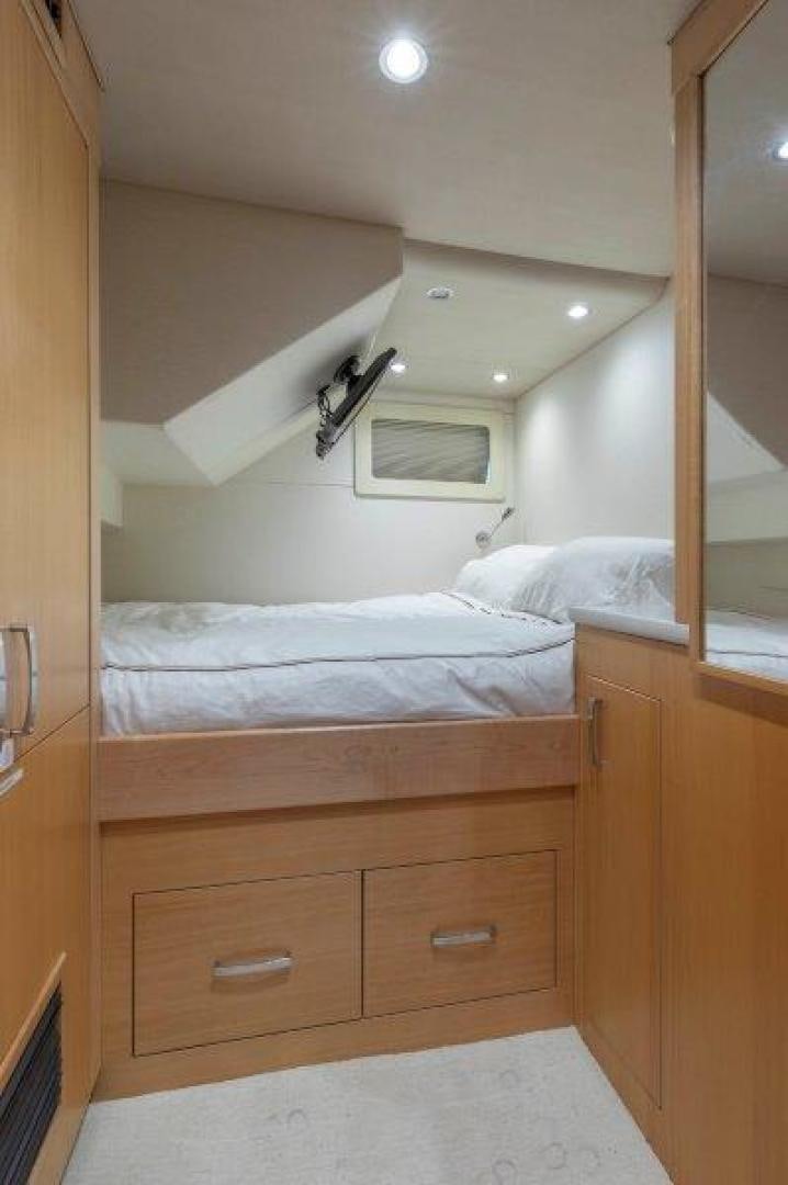 a room with a bed and a dresser aboard CHERRY BOMB Yacht for Sale