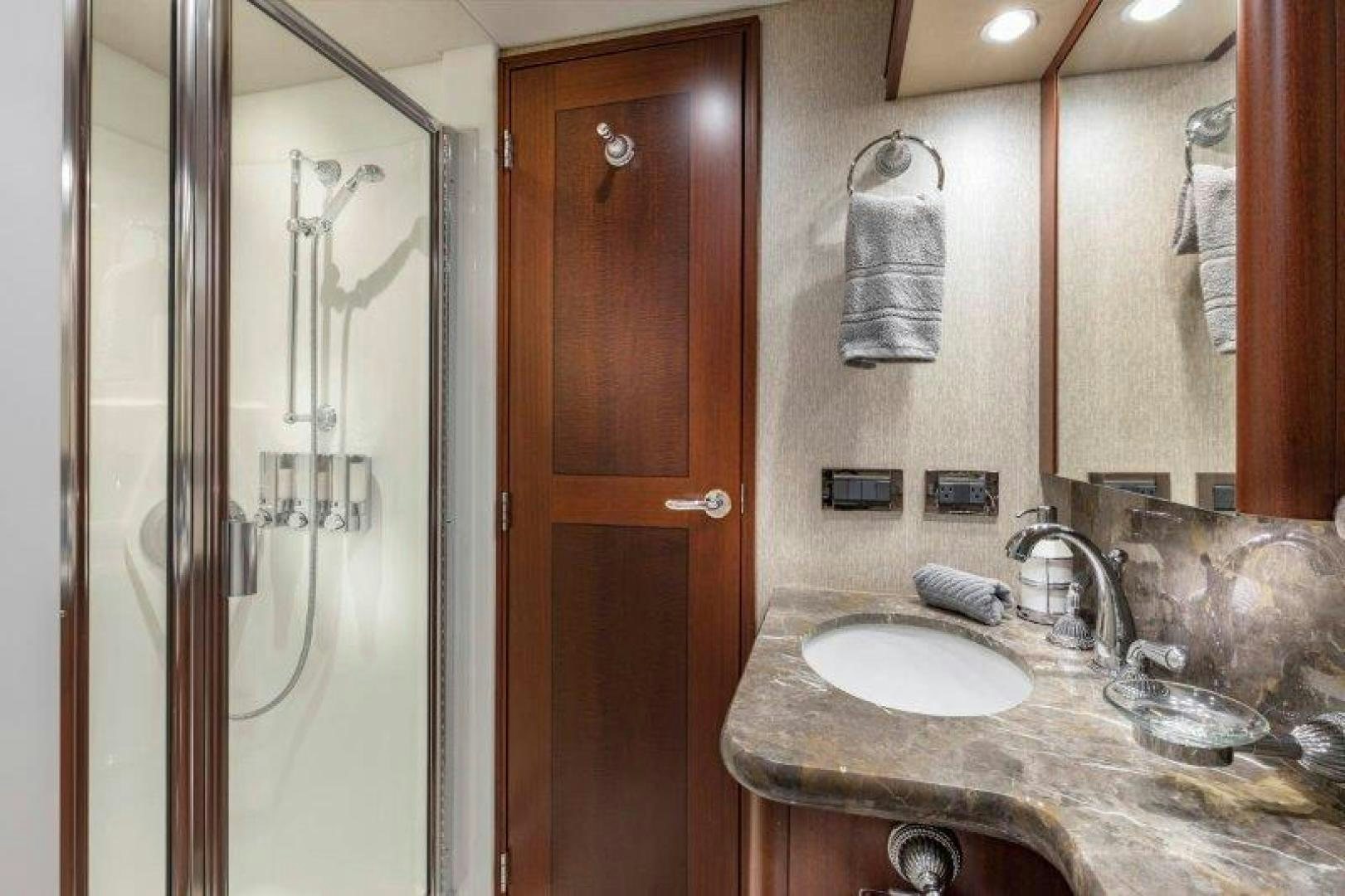 a bathroom with a glass shower door aboard CHERRY BOMB Yacht for Sale