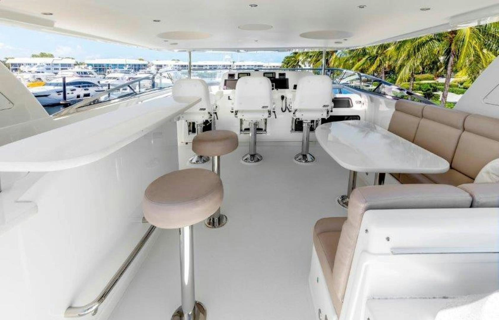 a room with a table chairs and a window with a view of the water aboard CHERRY BOMB Yacht for Sale
