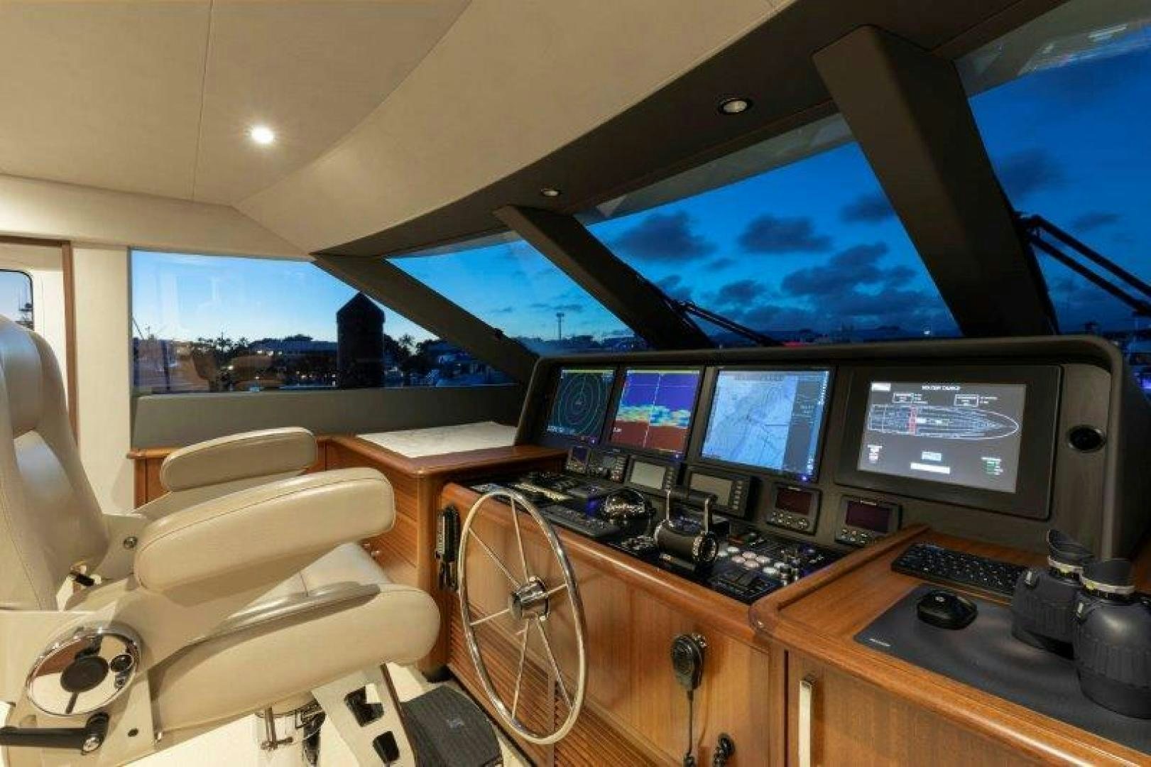 a room with many monitors and a chair aboard CHERRY BOMB Yacht for Sale