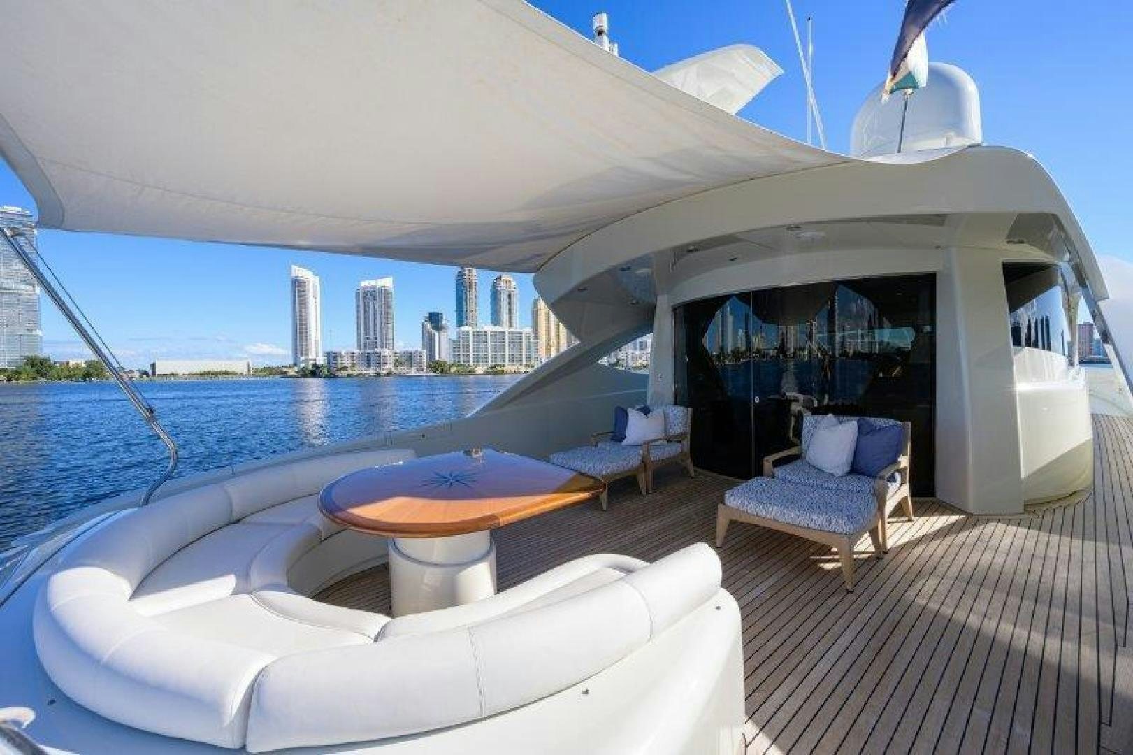a lounge area with a pool and a city in the background aboard VIRGINIA SEA Yacht for Sale