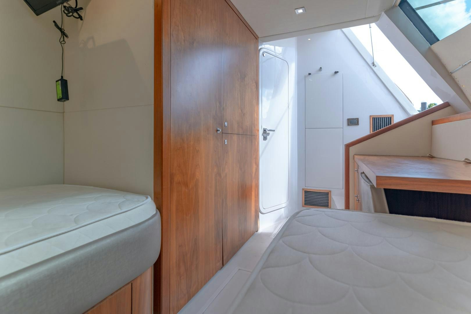 a room with a bed and a closet aboard SOL Y LUNA Yacht for Sale