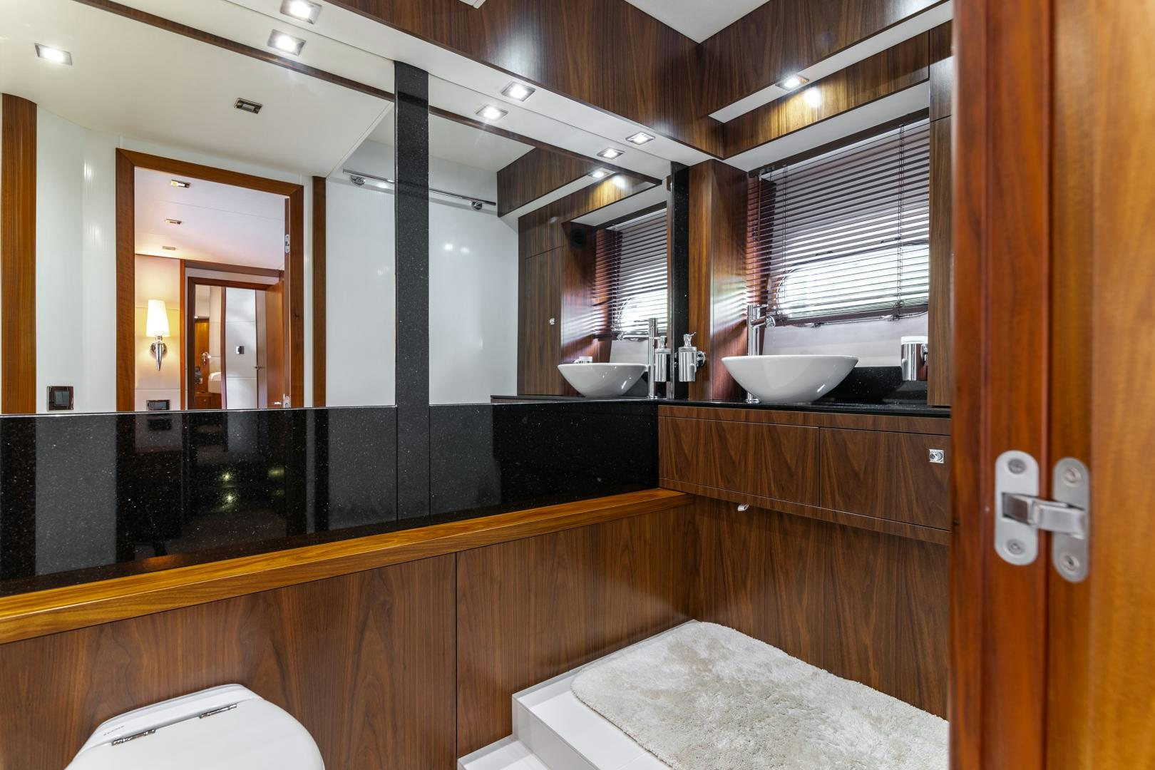 a bathroom with a sink and a mirror aboard SOL Y LUNA Yacht for Sale