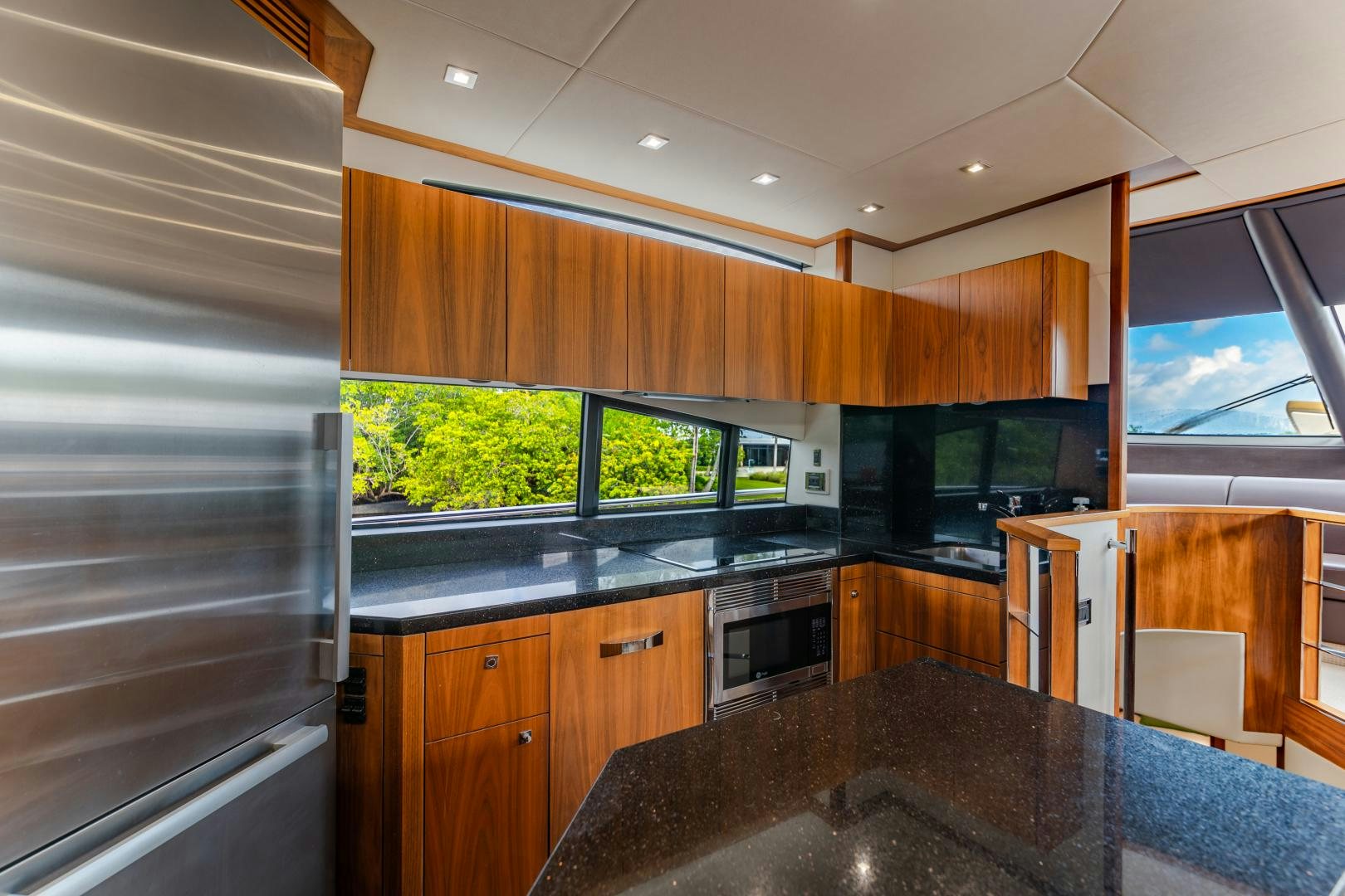 a kitchen with a large island aboard SOL Y LUNA Yacht for Sale