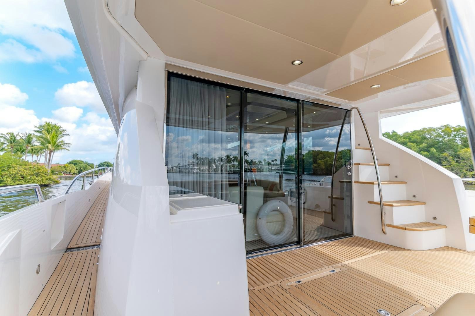 a room with glass doors and a view of the beach aboard SOL Y LUNA Yacht for Sale